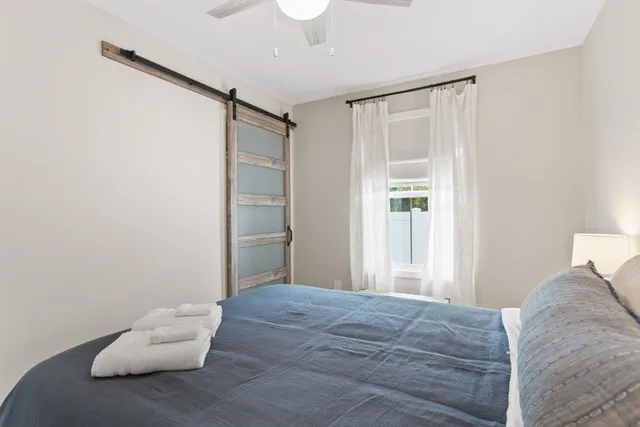 a living room with furniture and a ceiling fan