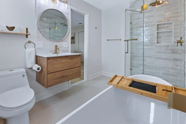 a view of a house with a big yard and large trees