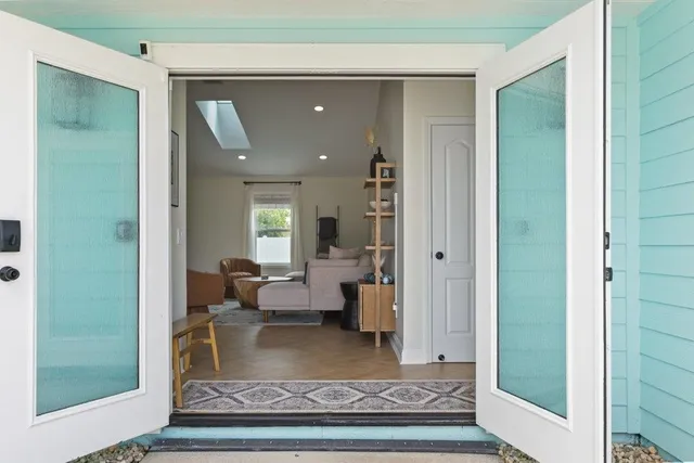 a living room with fireplace furniture and a large window