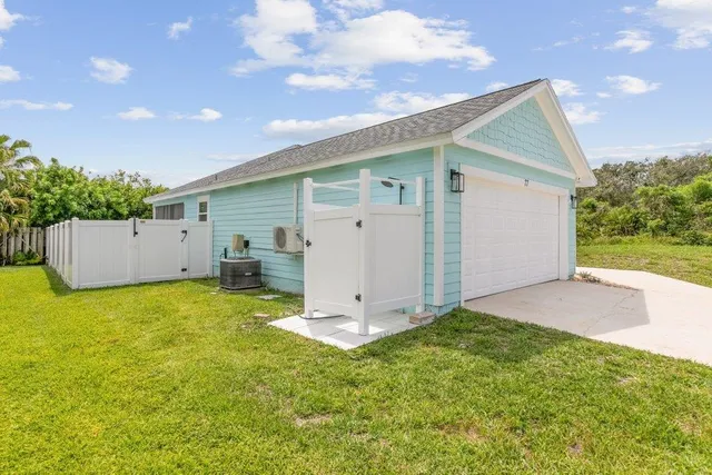 an aerial view of residential houses with outdoor space and street view