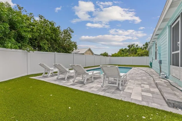 an aerial view of residential houses with outdoor space and trees