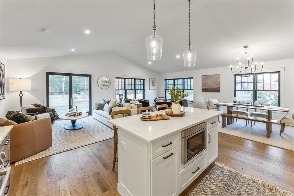 46 Sandwich Road, Unit 39 Plymouth, MA 02360 - Photo 15 of 41 a view of kitchen with kitchen island stainless steel appliances wooden floor dining table and chairs