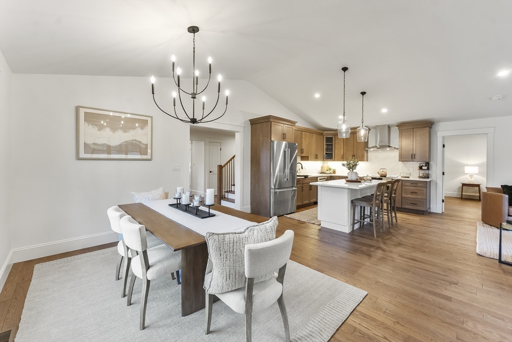 46 Sandwich Road, Unit 39 Plymouth, MA 02360 - Photo 23 of 41 a dining room with stainless steel appliances kitchen island granite countertop a dining table chairs and a refrigerator