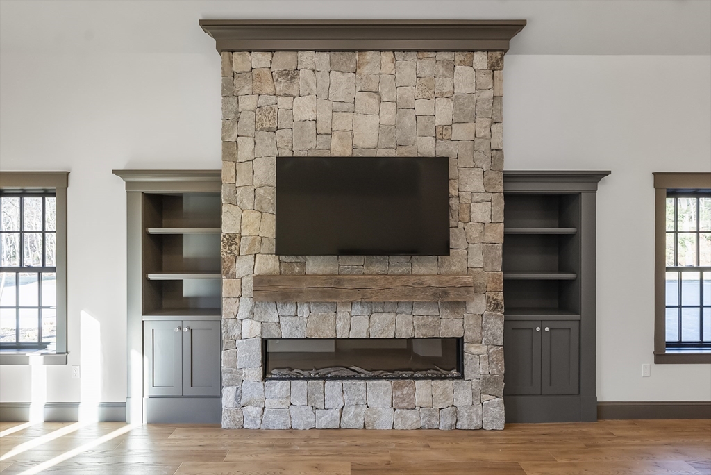 46 Sandwich Road, Unit 39 Plymouth, MA 02360 - Photo 40 of 41 a living room with a fireplace and a flat screen tv