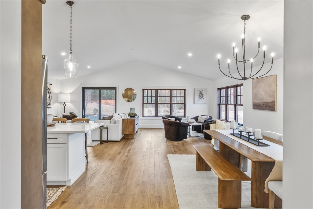 46 Sandwich Road, Unit 39 Plymouth, MA 02360 - Photo 7 of 41 a very nice looking living room with a dining table wooden floor and a chandelier