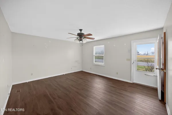 wooden floor in an empty room with a window