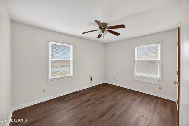 a kitchen with wooden floors and refrigerator