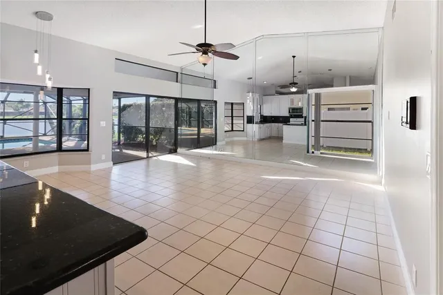a room with lots of white furniture and a chandelier