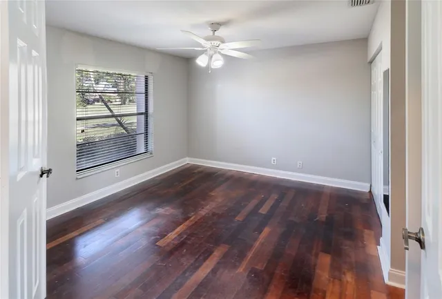 wooden floor in an empty room with a window