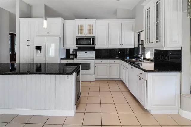 a kitchen with stainless steel appliances a sink a stove a microwave and cabinets