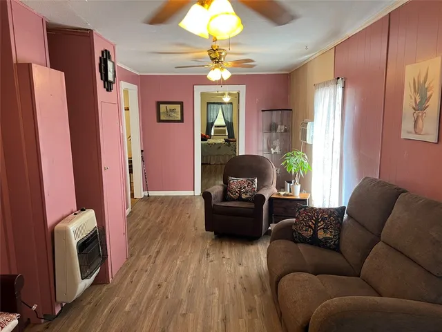 a living room with furniture a chandelier and a window