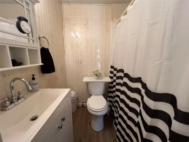 a bathroom with a sink a toilet and a mirror