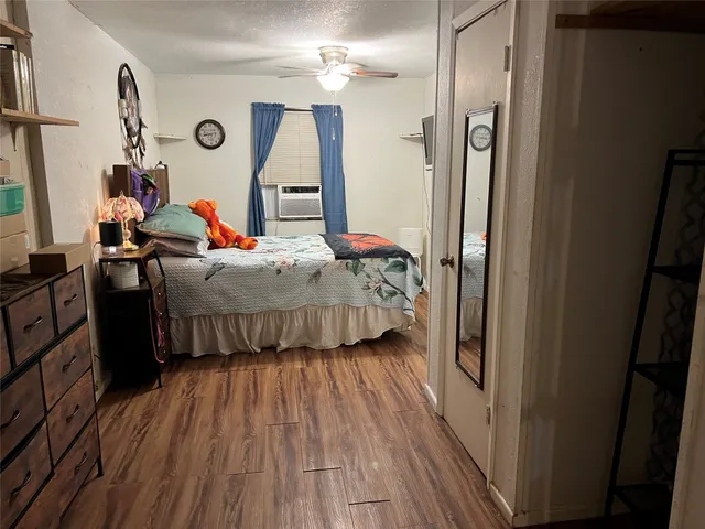 a bedroom with bed and a mirror