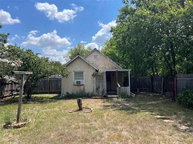 a backyard of a house with yard and outdoor seating