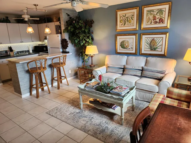 a living room with furniture and a potted plant