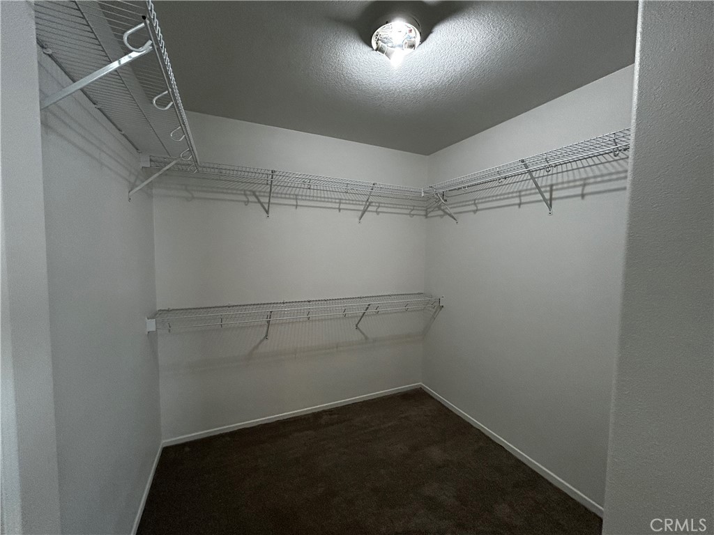 4210 Cloudywing Road Hemet, CA 92545 - Photo 17 of 27 a view of a room with racks on the wall