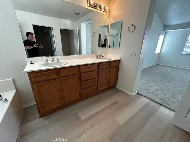 a bathroom with a double vanity sink and mirror