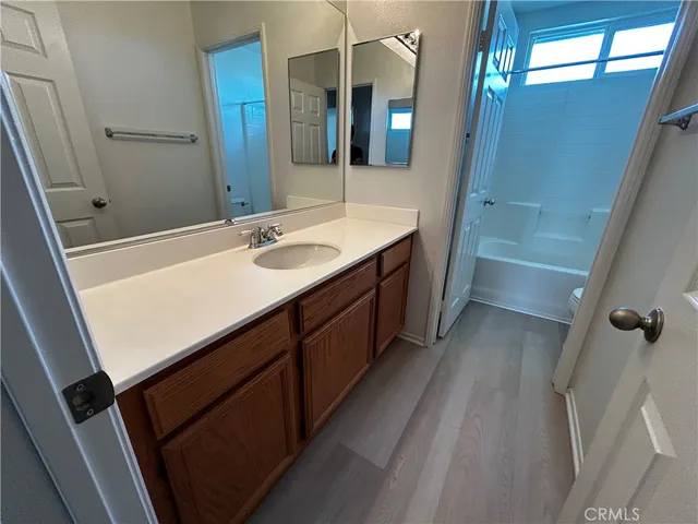 a bathroom with a sink a vanity and a mirror