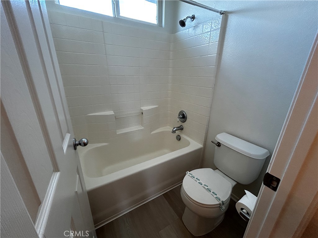 4210 Cloudywing Road Hemet, CA 92545 - Photo 22 of 27 a white toilet sitting next to a bath tub