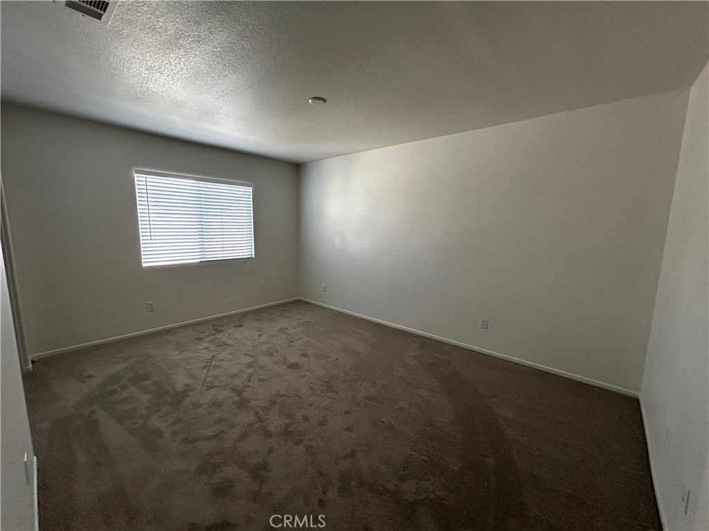 4210 Cloudywing Road Hemet, CA 92545 - Photo 24 of 27 an empty room with a window