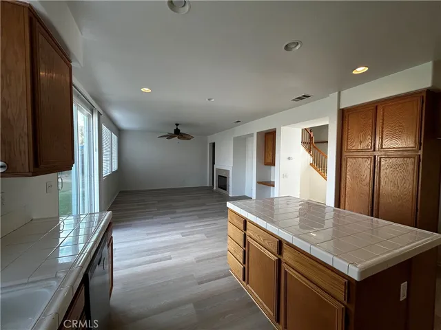 a kitchen with stainless steel appliances granite countertop a sink a stove and a refrigerator