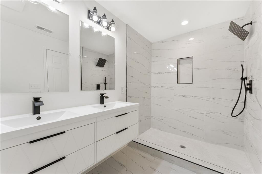 3406 Longleaf Drive Decatur, GA 30032 - Photo 17 of 29 a bathroom with a sink a shower and mirror