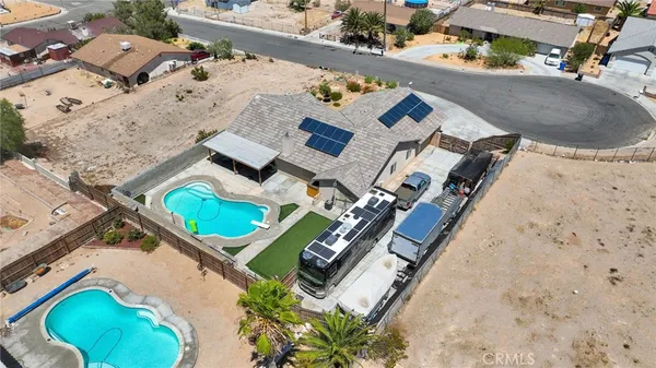 an aerial view of a house with a swimming pool
