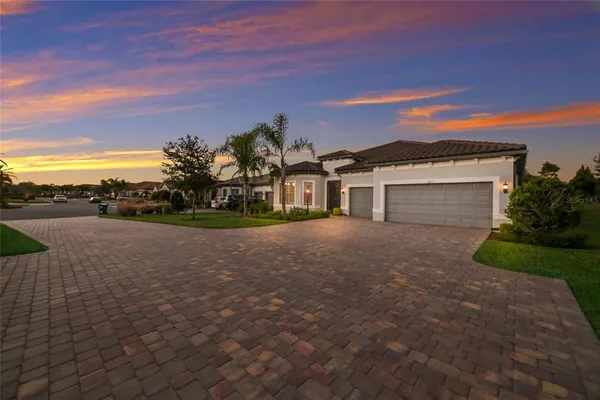 a front view of a house with a yard and a garage