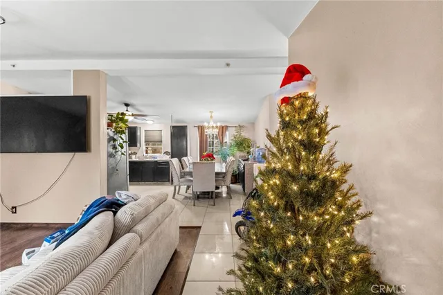 a living room with furniture a flat screen tv and a potted plant