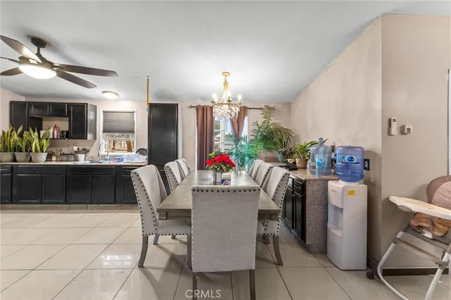 a dining room with furniture and a chandelier
