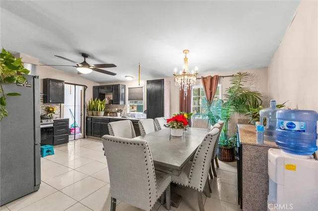a view of a dining room with furniture and chandelier