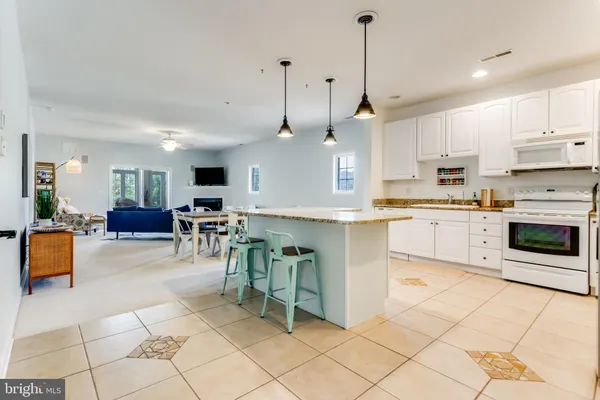 a kitchen with cabinets and chairs