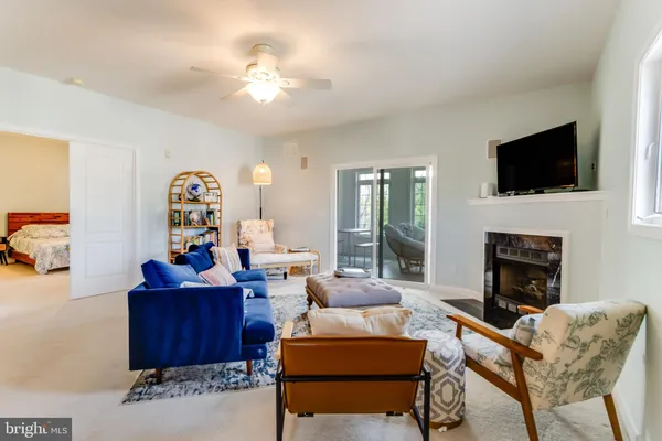 a living room with furniture a fireplace and a flat screen tv
