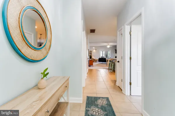 a hallway with a dining table and a mirror