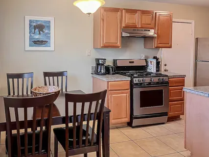 a kitchen with stainless steel appliances a stove a sink dishwasher and cabinets