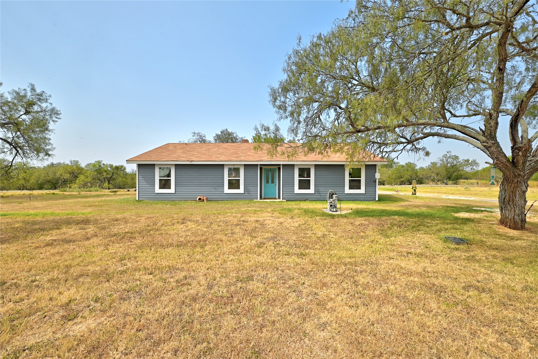 311 Salt Lake Road Luling, TX 78648 - Photo 26 of 37 Mature trees shade the spacious lawn of this classic single-story home. \