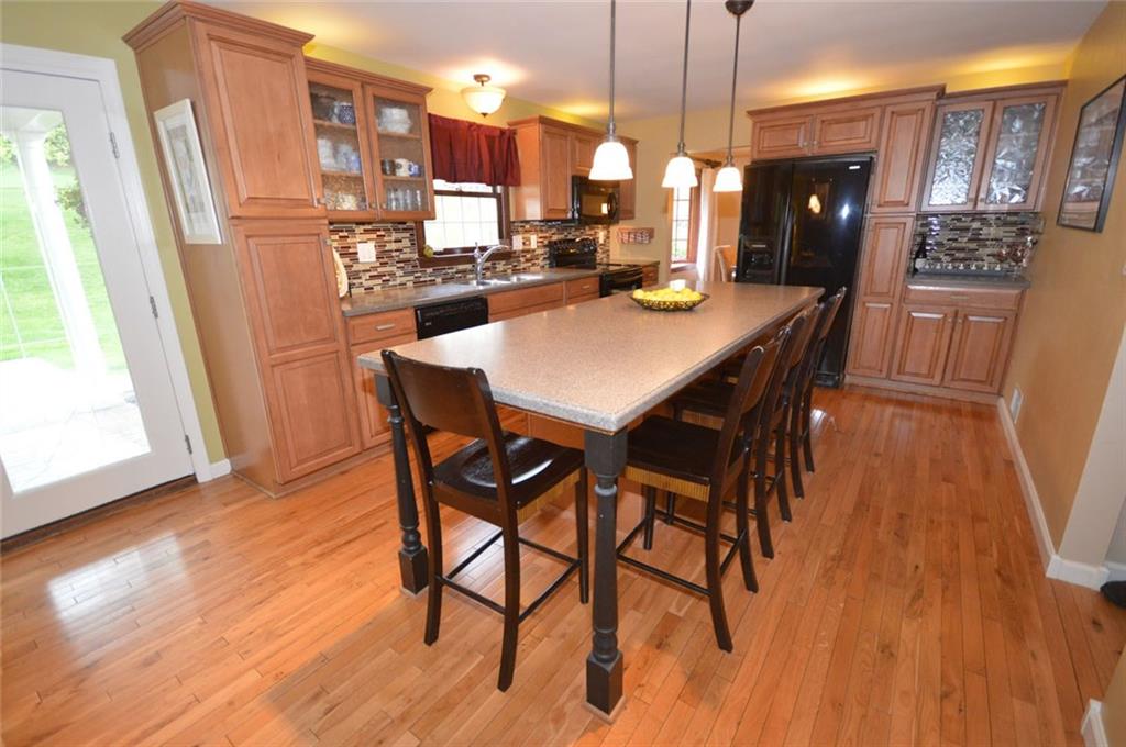 107 Yorktown Road Canonsburg, PA 15317 - Photo 8 of 25 WOW! The state-of-the-art kitchen is a chef's dream. Beautiful maple cabinetry, gleaming hardwood flooring, a huge island for prep work/serving/dining, a built-in wine rack and beautiful backsplash make every day chores a delight!