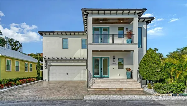 a front view of a house with a garden