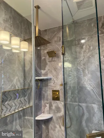 a bathroom with a glass shower door
