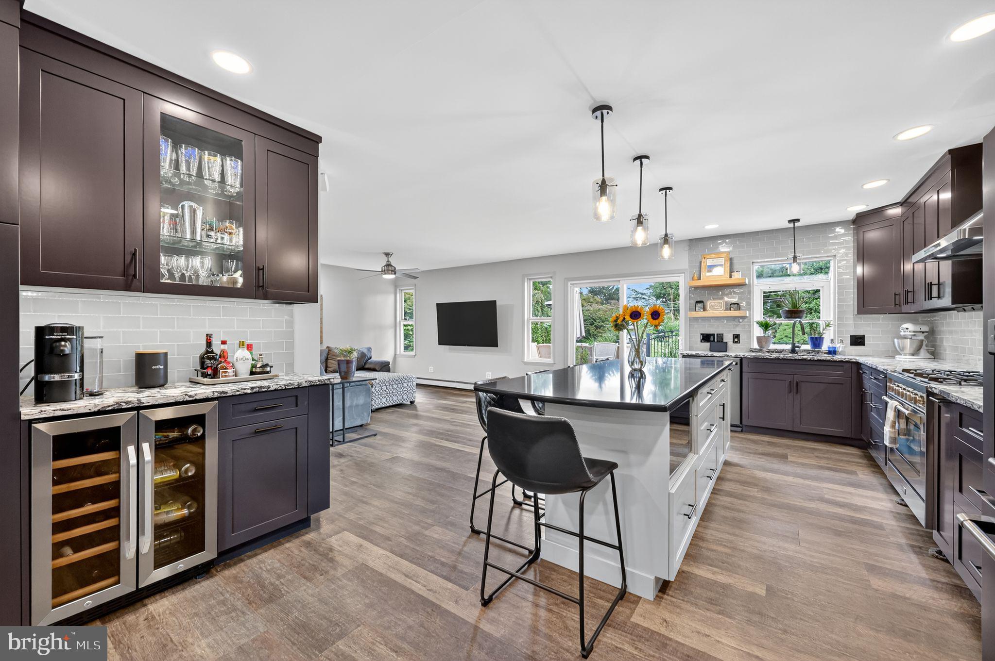 657 Pembroke Road Rydal, PA 19046 - Photo 14 of 36 a kitchen with stainless steel appliances a stove a sink dishwasher a oven with a dining table and chairs