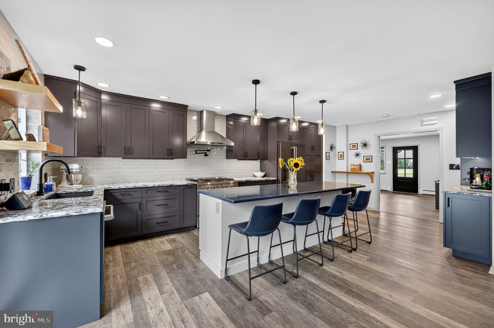 657 Pembroke Road Rydal, PA 19046 - Photo 15 of 36 a open kitchen with granite countertop a sink cabinets and wooden floor