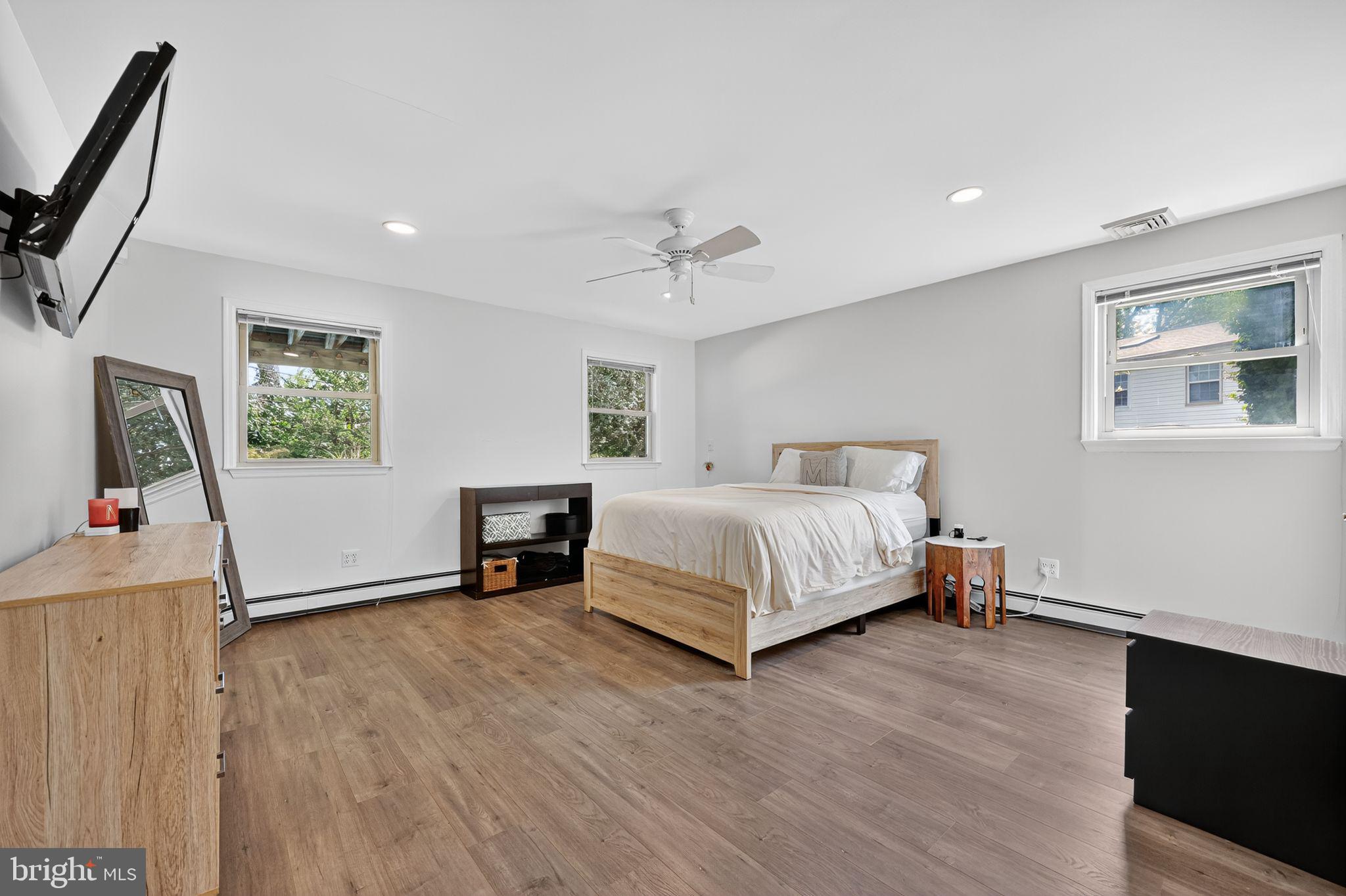 657 Pembroke Road Rydal, PA 19046 - Photo 25 of 36 a bedroom with a bed a table and painting on the wall