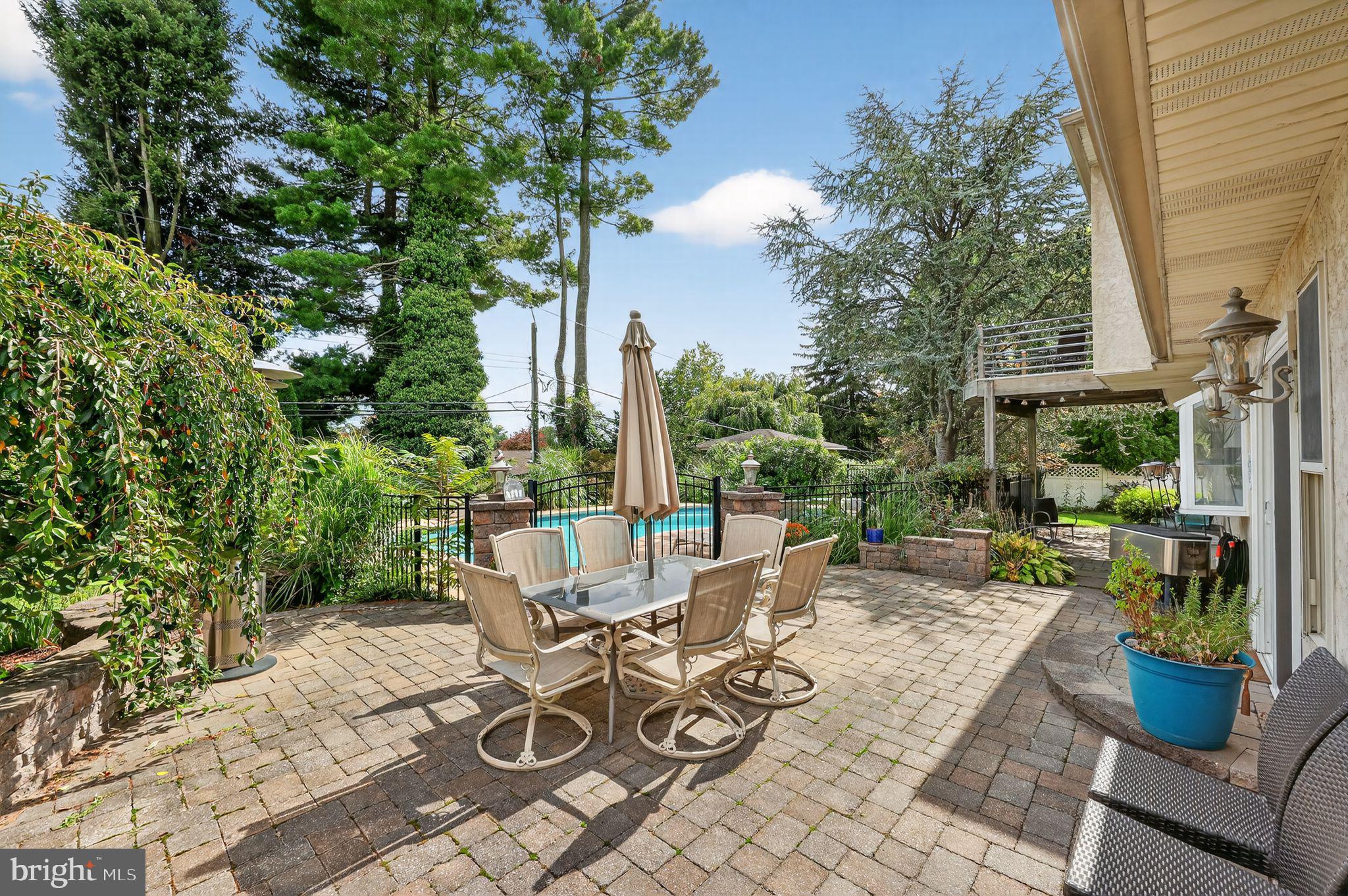 657 Pembroke Road Rydal, PA 19046 - Photo 8 of 36 a view of a patio with couches potted plants and tree