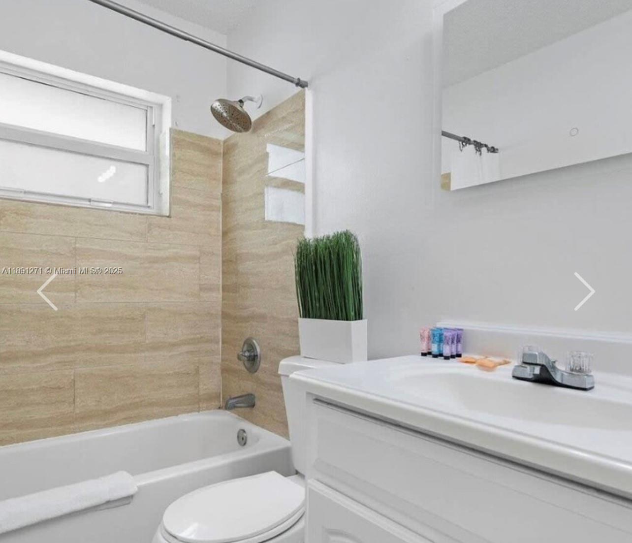 2421 Southwest 58th Manor, Unit 1 Dania Beach, FL 33312 - Photo 11 of 15 a bathroom with a bathtub sink and toilet