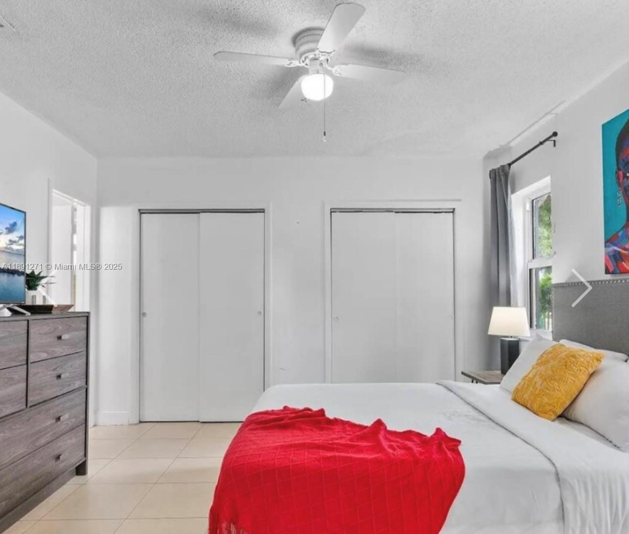 2421 Southwest 58th Manor, Unit 1 Dania Beach, FL 33312 - Photo 14 of 15 a bedroom with a bed and closet