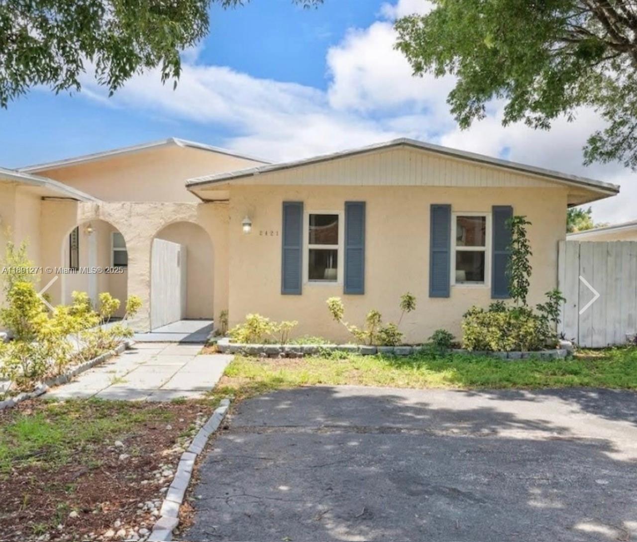 2421 Southwest 58th Manor, Unit 1 Dania Beach, FL 33312 - Photo 15 of 15 a view of a house with backyard and sitting area