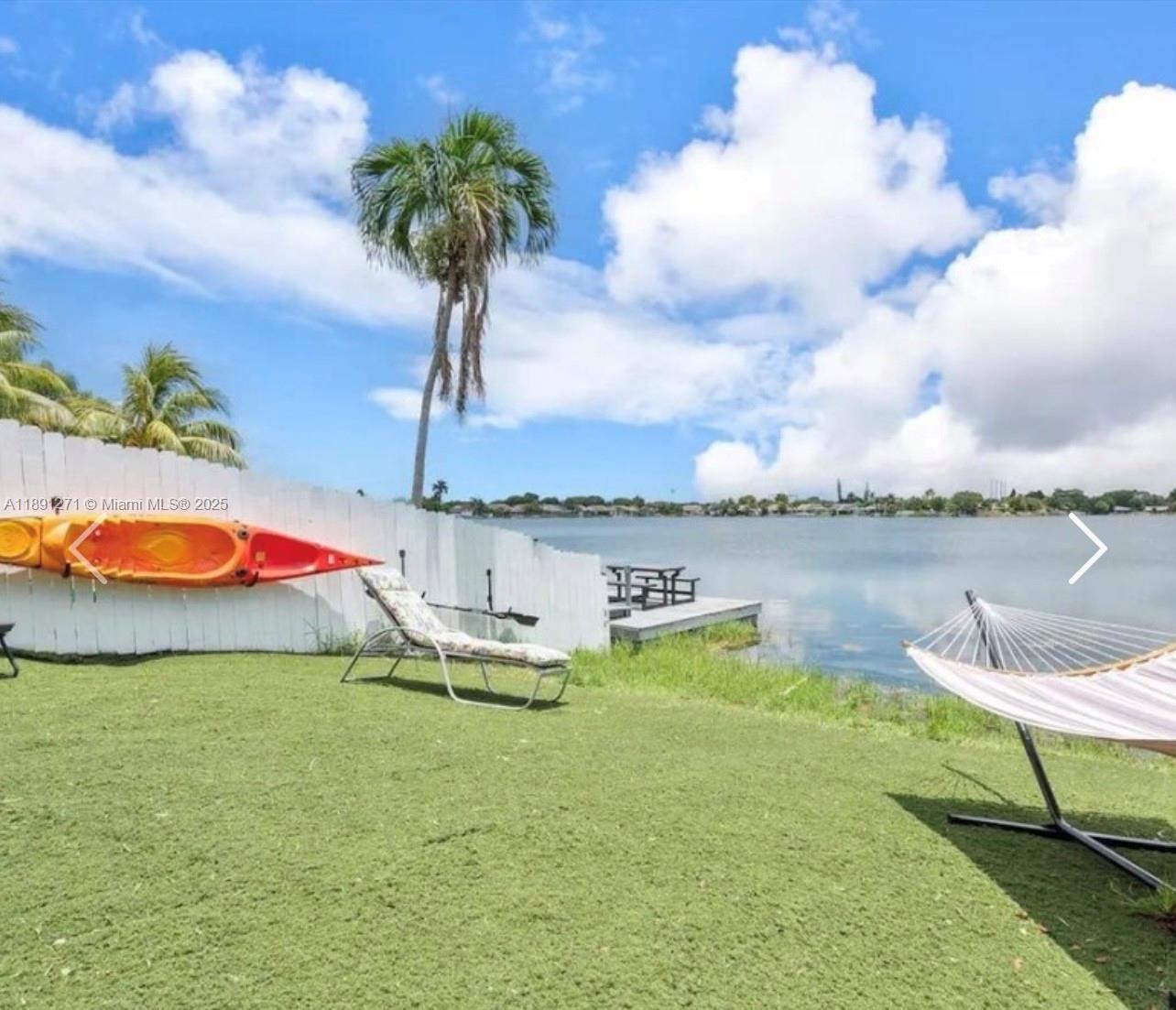 2421 Southwest 58th Manor, Unit 1 Dania Beach, FL 33312 - Photo 4 of 15 a view of a lake with a swimming pool and a yard