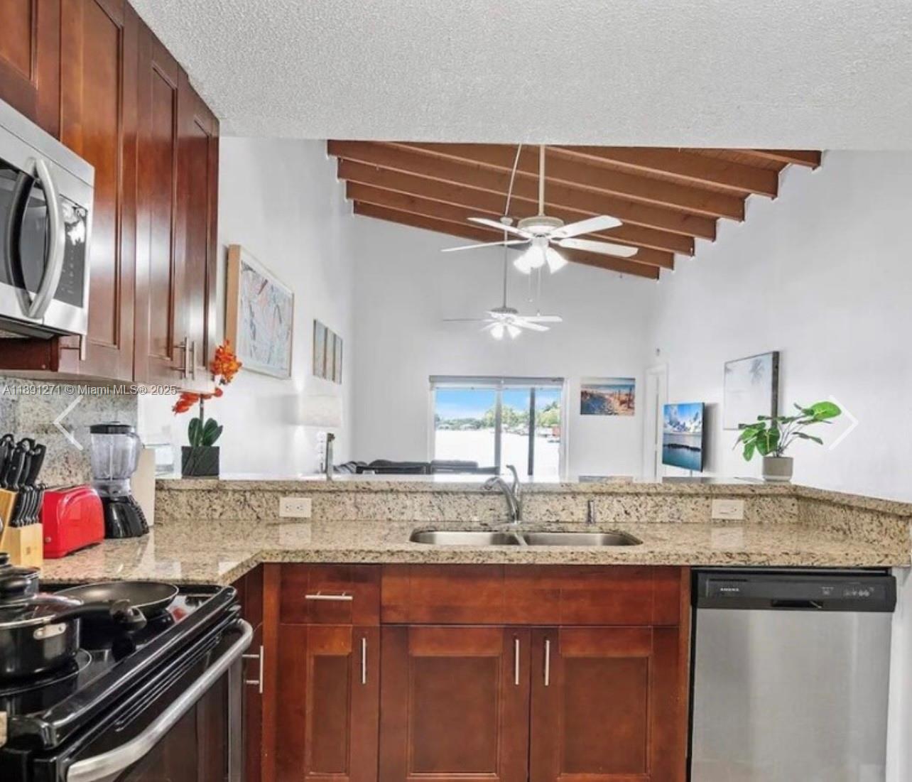 2421 Southwest 58th Manor, Unit 1 Dania Beach, FL 33312 - Photo 5 of 15 a kitchen with granite countertop a sink stainless steel appliances and cabinets