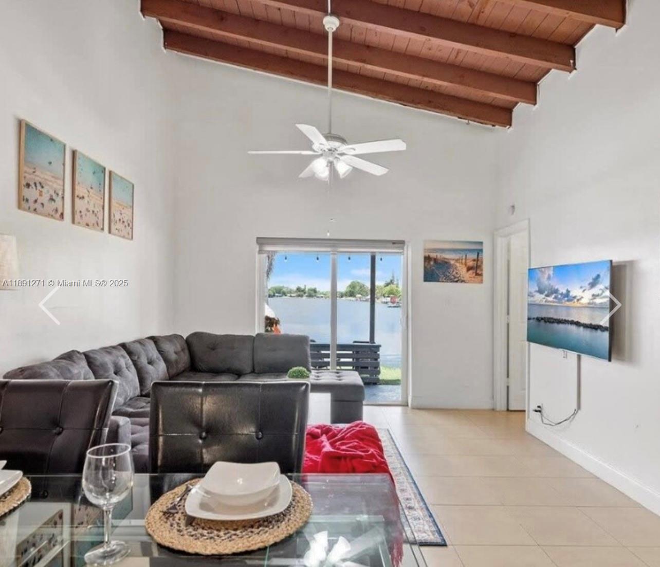 2421 Southwest 58th Manor, Unit 1 Dania Beach, FL 33312 - Photo 8 of 15 a living room with furniture and a large window