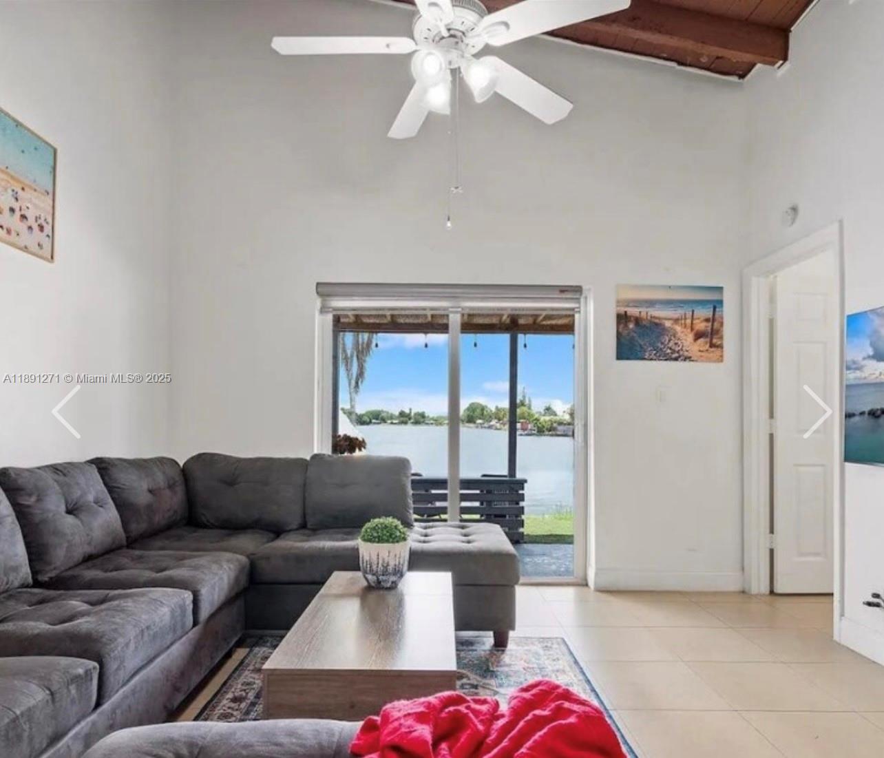 2421 Southwest 58th Manor, Unit 1 Dania Beach, FL 33312 - Photo 9 of 15 a living room with furniture and a large window
